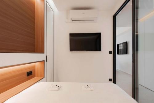 une chambre avec un lit et une télévision à écran plat dans l'établissement T2 Neuf et chic à deux pas de la Croisette, à Cannes