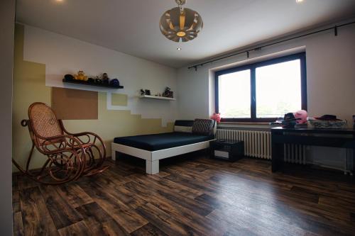 a room with a bench and a chair and a window at Grand Prix Villa Popůvky in Popůvky