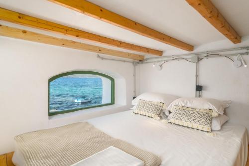 a bedroom with a large bed and a window at Aganta Klima Syrma in Klima