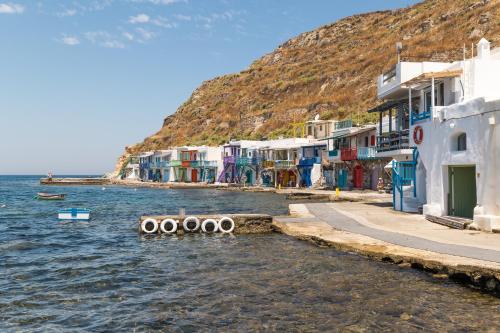 a group of buildings next to the water at Aganta Klima Syrma in Klima