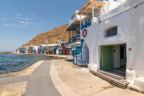 a street next to the water next to a building at Aganta Klima Syrma in Klima