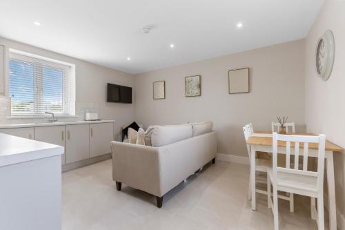 a kitchen and living room with a couch and a table at The Mail Rooms Limavady - Boutique Stays in Limavady