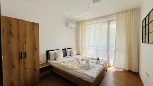 a bedroom with a bed and a large window at ASTORIA II Apartment 54 One Bedroom in Elenite