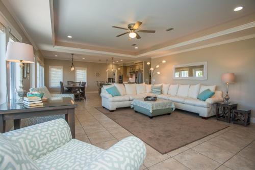 a living room with white couches and a dining room at Heaven's Walk in Indian Pass