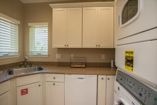 a kitchen with white cabinets and a sink at Heaven's Walk in Indian Pass