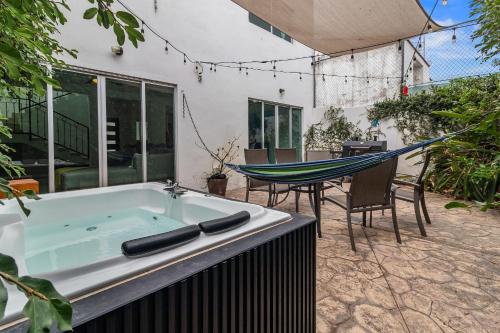 a bath tub with a hammock in a backyard at Casa Encanto - 3Bdr, 2.5bath w/Jacuzzi and Parking in Puerto Vallarta