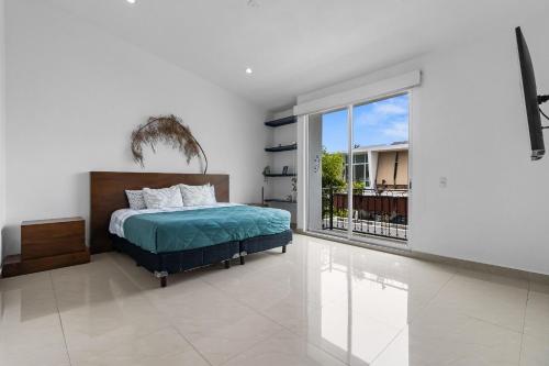 a bedroom with a bed and a large window at Casa Encanto - 3Bdr, 2.5bath w/Jacuzzi and Parking in Puerto Vallarta