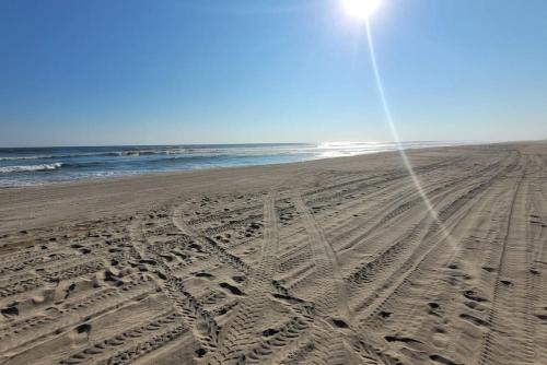 an empty beach with footprints in the sand at Paktinemi Diamante Fantastic View Beach Club in Acapulco