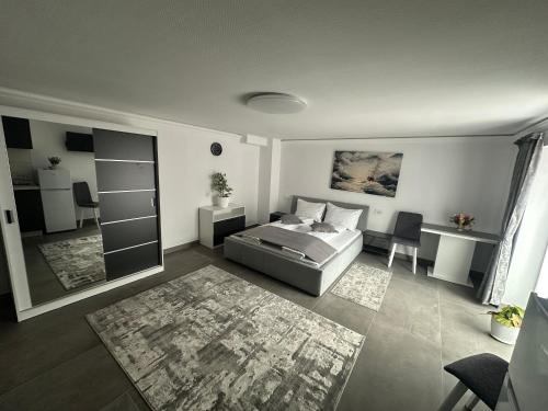 a living room with a bed and a desk at Fram Apartments in Soci