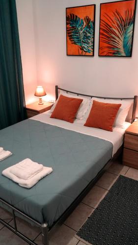 a bed in a room with two pillows on it at IKARUS apartment with courtyard & pool in Chania in Stérnai