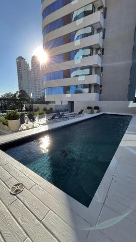 a swimming pool in front of a tall building at Torres Brickell Six in Tigre