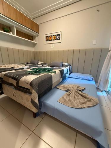 two beds sitting next to each other in a room at Palm Beach Residence in Aquiraz