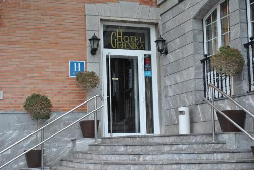 a front door of a building with stairs in front at Hotel Gernika - Adults Only in Guernica y Luno