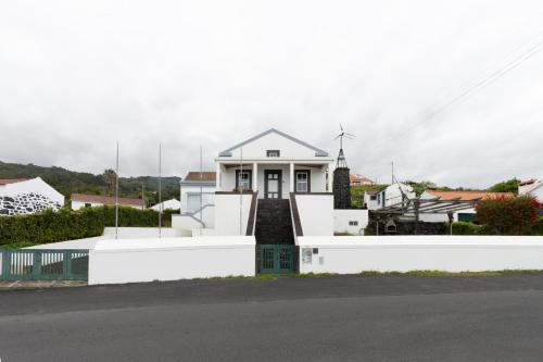 a white house with a white fence at Casa da Torre in São João