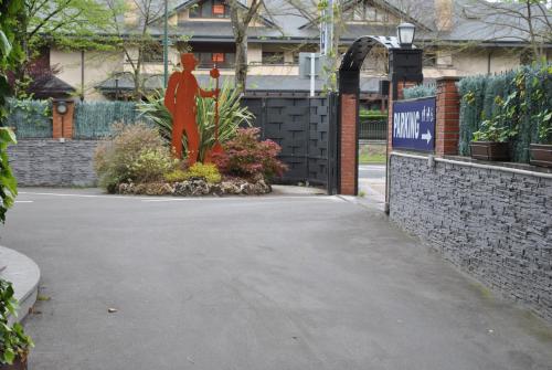 a driveway in front of a house with a statue at Hotel Gernika - Adults Only in Guernica y Luno
