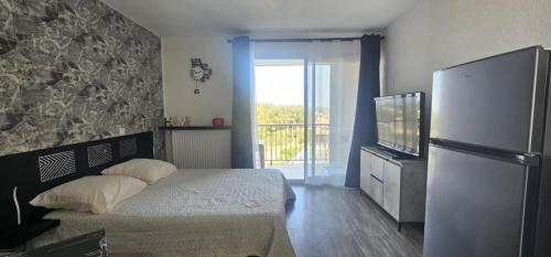 une chambre avec un lit et une télévision dans l'établissement La Dolce Vita, à Balaruc-les-Bains