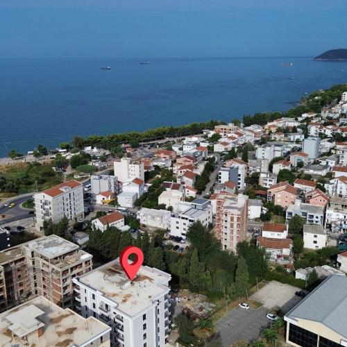 a city with a red arrow on top of a building at Apartman Adriatico 10 in Bar, Susanj