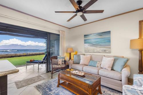 a living room with a couch and a table at Direct Oceanfront Beach Pohailani Studio - New in Kahana