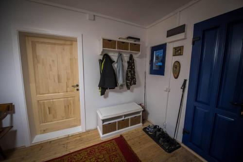 a room with a door and a bench next to a door at Casa cu copaci Romanian historical farmhouse in Mărişel