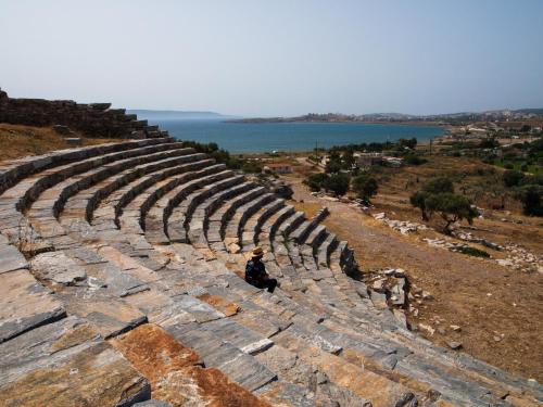 a person sitting on the edge of an amphitheater at Hidesign Athens Villa In Sounio in Sounio