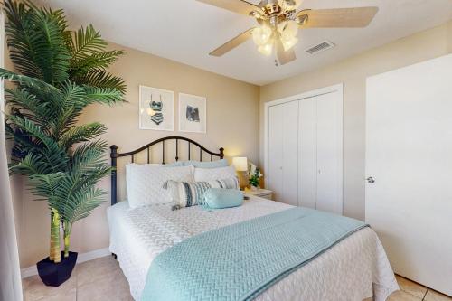 a bedroom with a bed with a ceiling fan at Lagoon Landing #302 in Gulf Shores