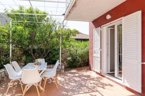 a patio with a table and chairs and a building at Holiday Home Mareta in Dubrovnik
