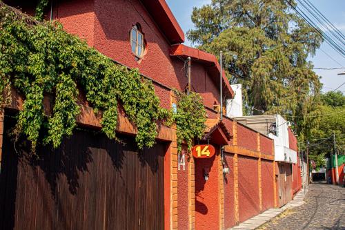 a red brick building with a number forty on it at La Casita de Coyoacán in Mexico City