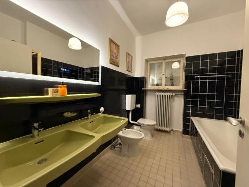 a bathroom with a tub and a toilet and a sink at LauternLodge - Hideaway in Blaustein