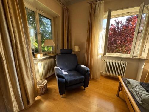 a living room with a chair and a window at LauternLodge - Hideaway in Blaustein