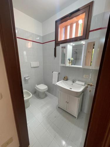 ein weißes Badezimmer mit Waschbecken und Toilette in der Unterkunft Casa Lago in Bellagio in Bellagio