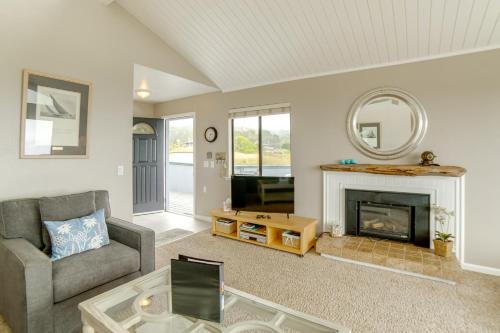 a living room with a couch and a fireplace at Beach Access and Hot Tub Coastal Gem in Manchester in Manchester