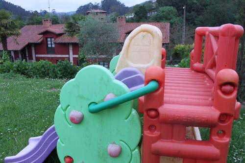 a childs play set with an elephant on a playground at La Casona de la Roza in Valbucar