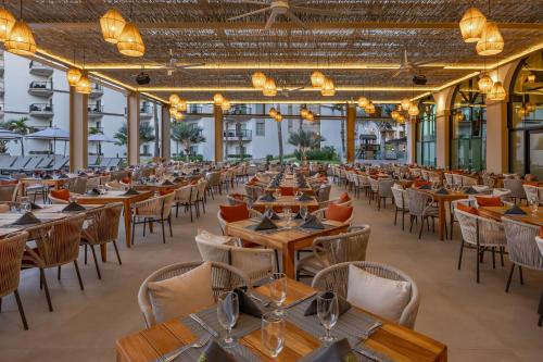 a large dining room with tables and chairs at Villa del Palmar Beach Resort & Spa in Cabo San Lucas