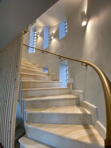 a staircase in a house with white steps at Luxury SeaView Villa Pool-Bbq in Neos Voutzas