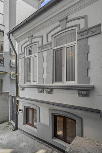 a building with three windows on the side of it at Interbelic Villa close to Old Town in Bucharest