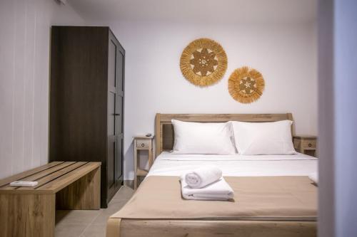 a bedroom with a bed with two towels on it at Magic Holidays 222 in Mýkonos City