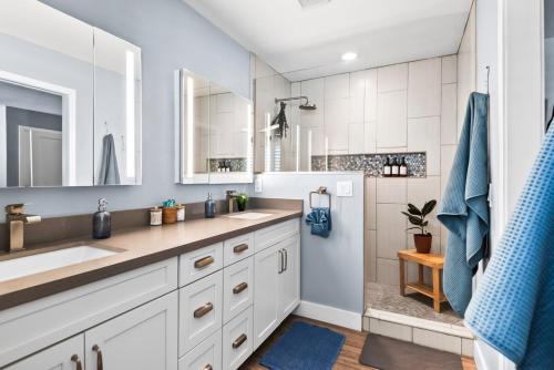 a white bathroom with two sinks and a shower at Scottsdale Getaway with Hot Tub Games and Office in Scottsdale