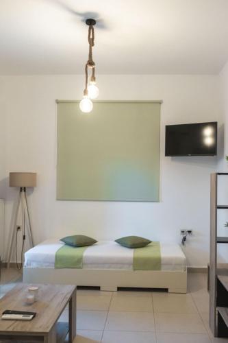 a bedroom with a bed and a table at Myrthe Apartments in Myrtos
