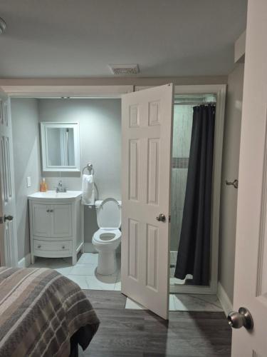 a bedroom with a bathroom with a toilet and a sink at Whitby one bedroom apartment in Whitby