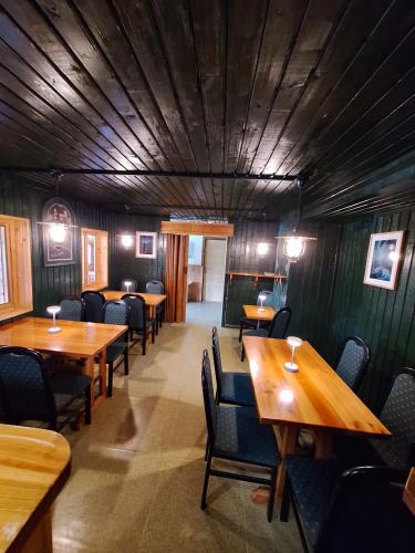 a dining room with wooden tables and chairs at Chata Polárka in Pec pod Sněžkou