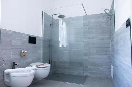 a bathroom with a toilet and a glass shower at Agriturismo Valle Isola "La Tana del Gusto" in Comacchio