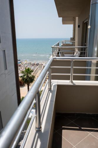 a balcony of a building with a view of the ocean at Rumar Hotel in Durrës