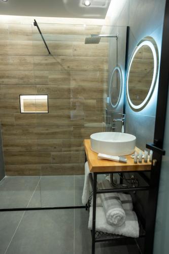 a bathroom with a sink and a shower at Rumar Hotel in Durrës
