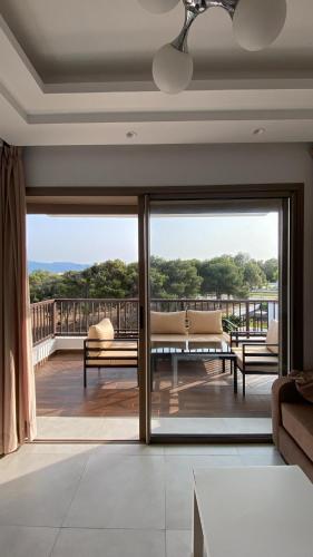 a living room with a large sliding glass door at Soleil & Compagnie Cabo Huerto in Cabo Negro