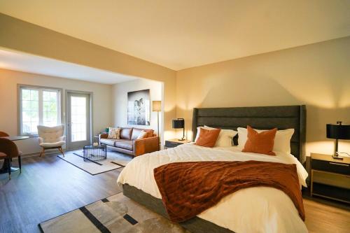 a bedroom with a large bed and a living room at Lower Level LuxSuite - 1min Walk from Heated Pool! in Shanty Bay