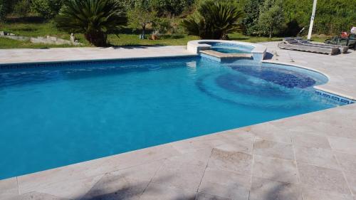 une grande piscine avec de l'eau bleue dans l'établissement charming villa with pool, à Bastelicaccia