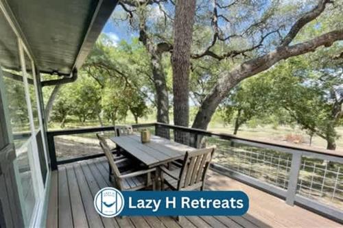 a deck with a table and chairs and a tree at River Access Pet Friendly Fishing BBQ Sleeps 5 in Kyle
