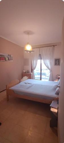 a large bed in a bedroom with a window at Sea view in Nea Peramos