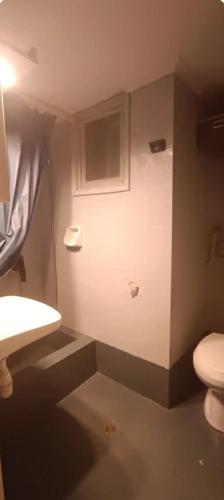 a small bathroom with a toilet and a sink at Sea view in Nea Peramos