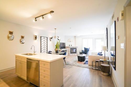 a kitchen and living room with a sink and a counter at King bed, Jacuzzi Suite with full kitchen in Shanty Bay